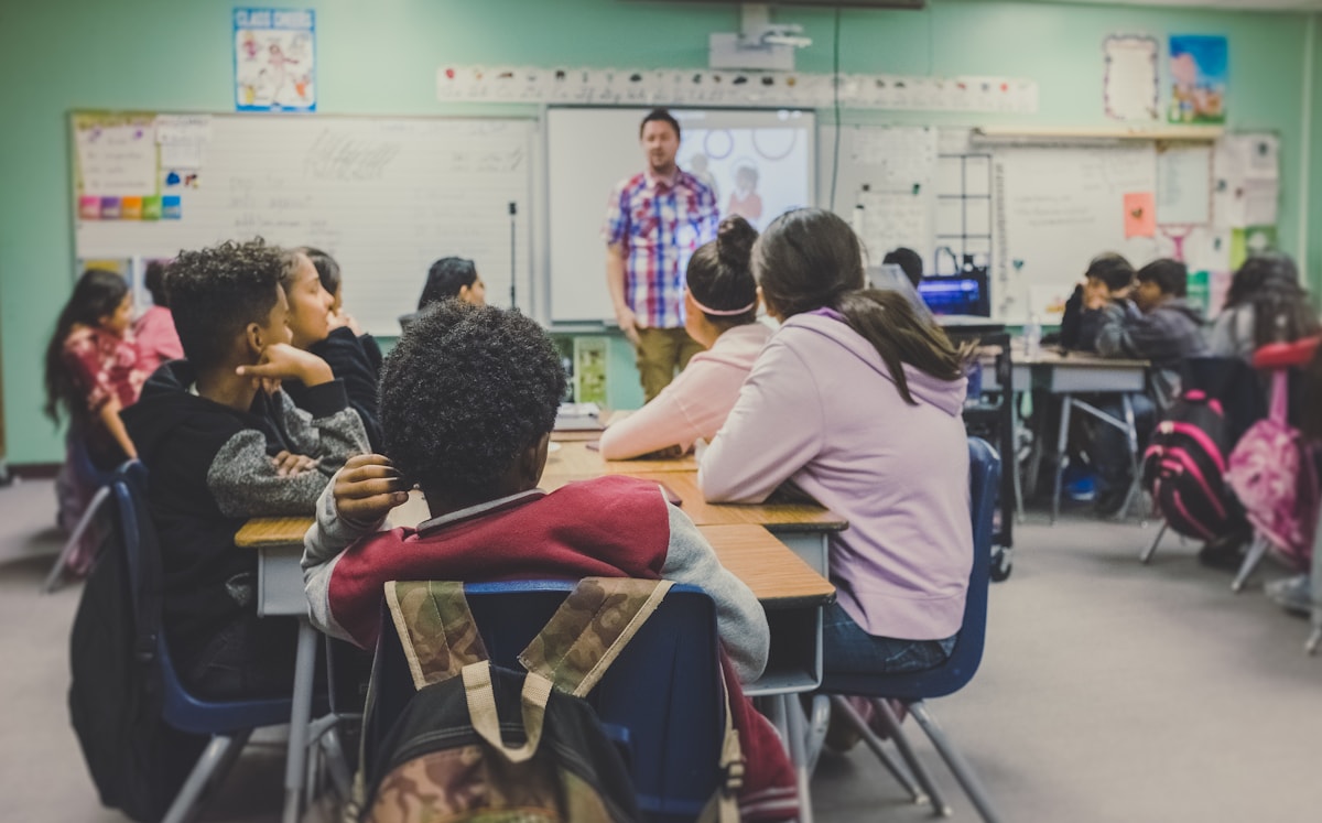 Teacher helping learners in a classroom